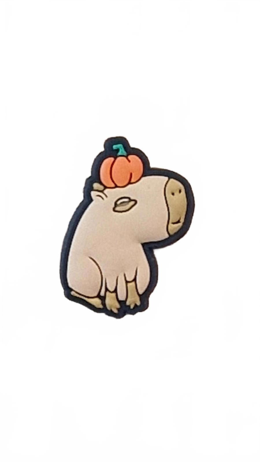 Cartoon capybara sitting with pumpkin on head with a white background shoe charm