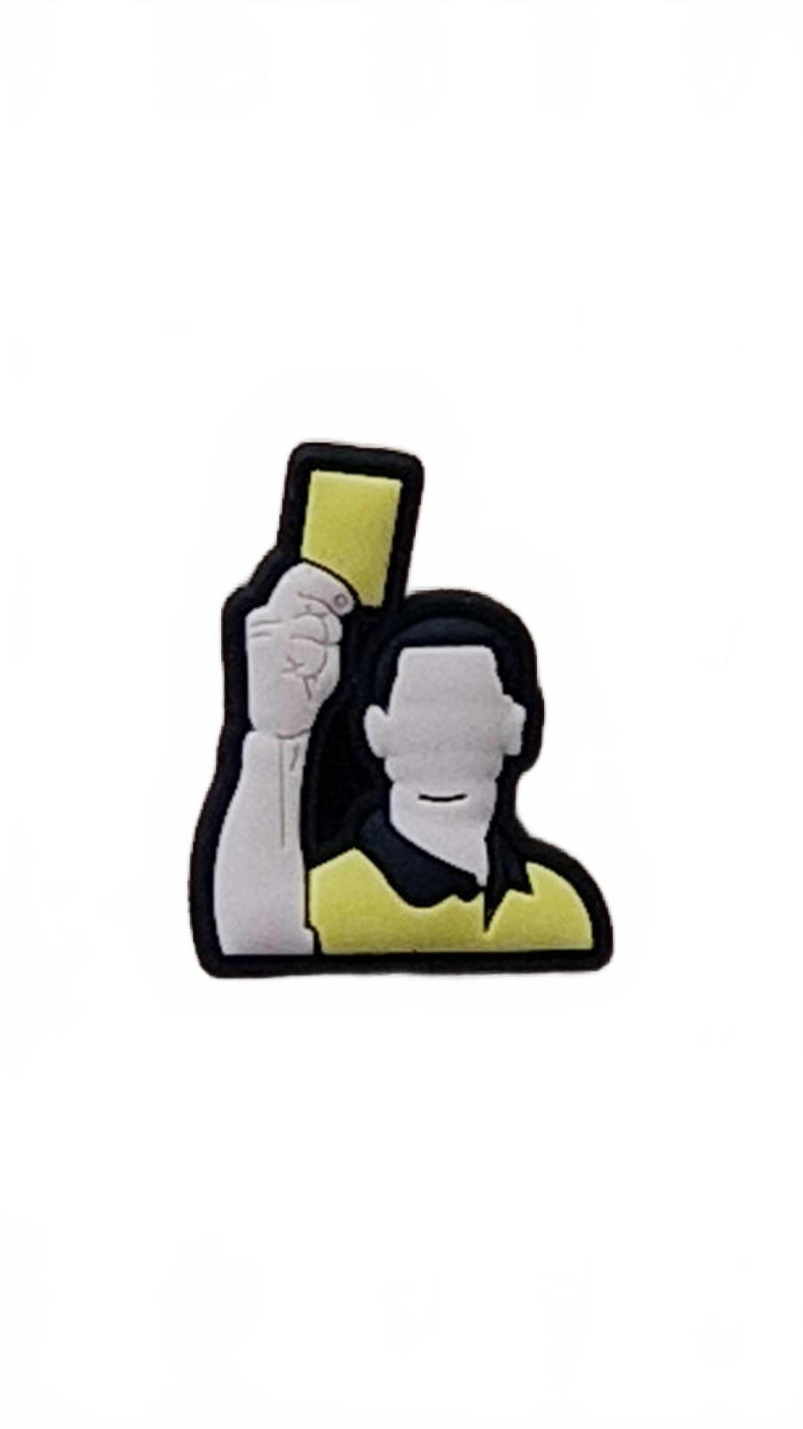 Sports referee with yellow shirt holding up yellow card shoe charm