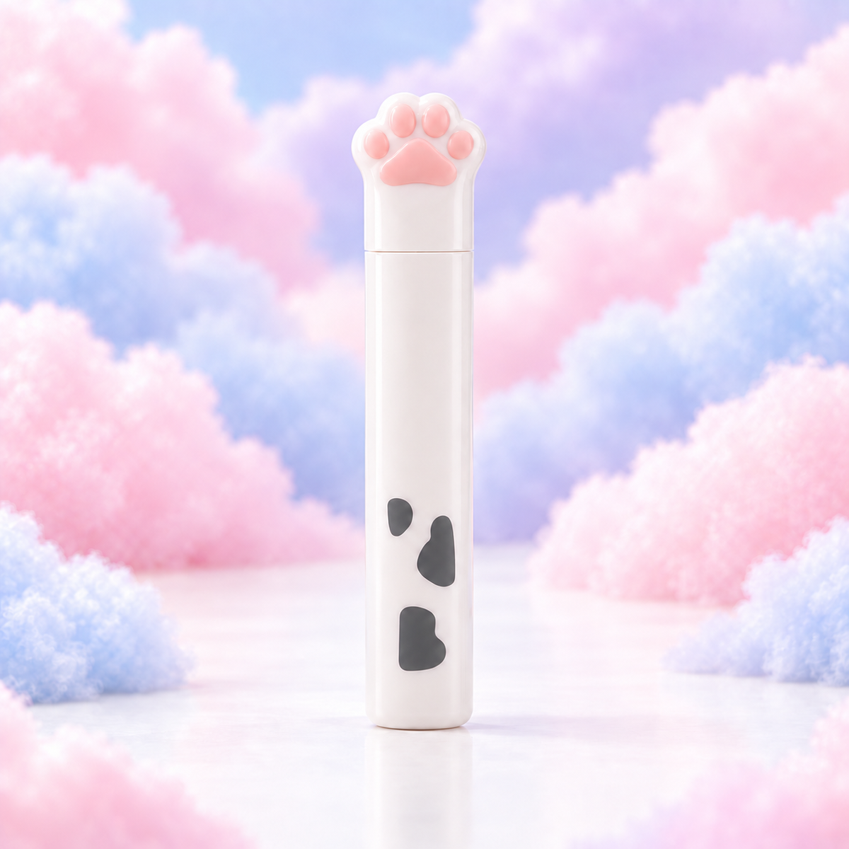 White cow-print compact cat paw scissors in a protective case on pastel clouds.