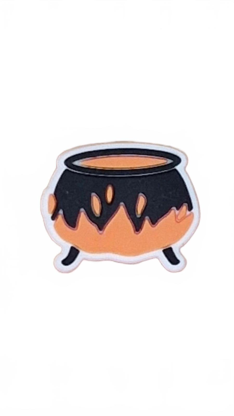 Black and orange cauldron shoe charm on a white background