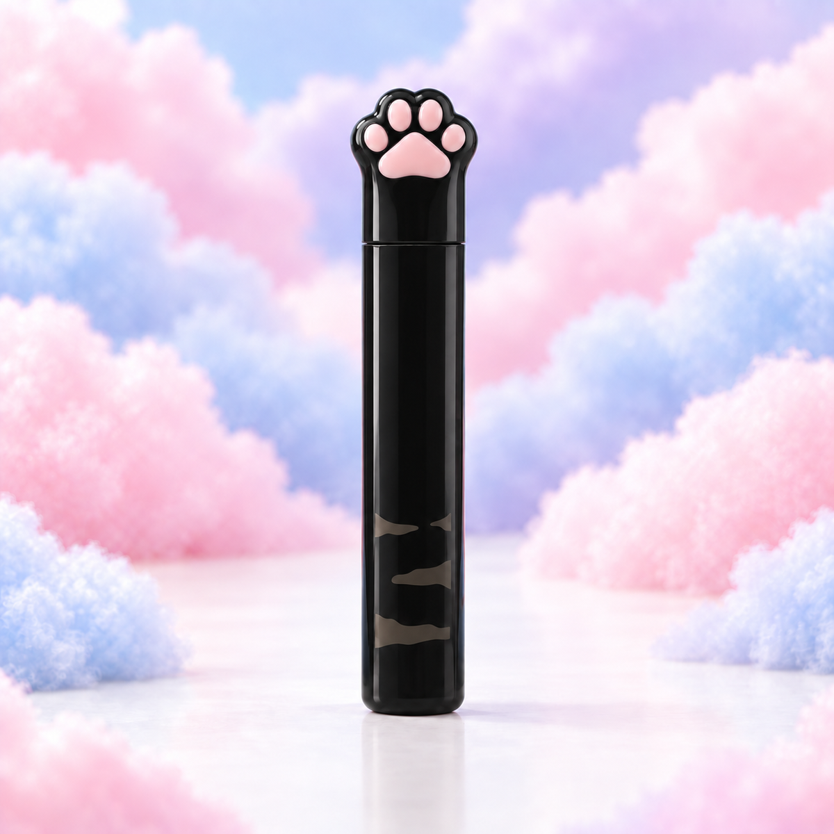 Black compact cat paw scissors with a pink paw detail in a protective case on pastel clouds.