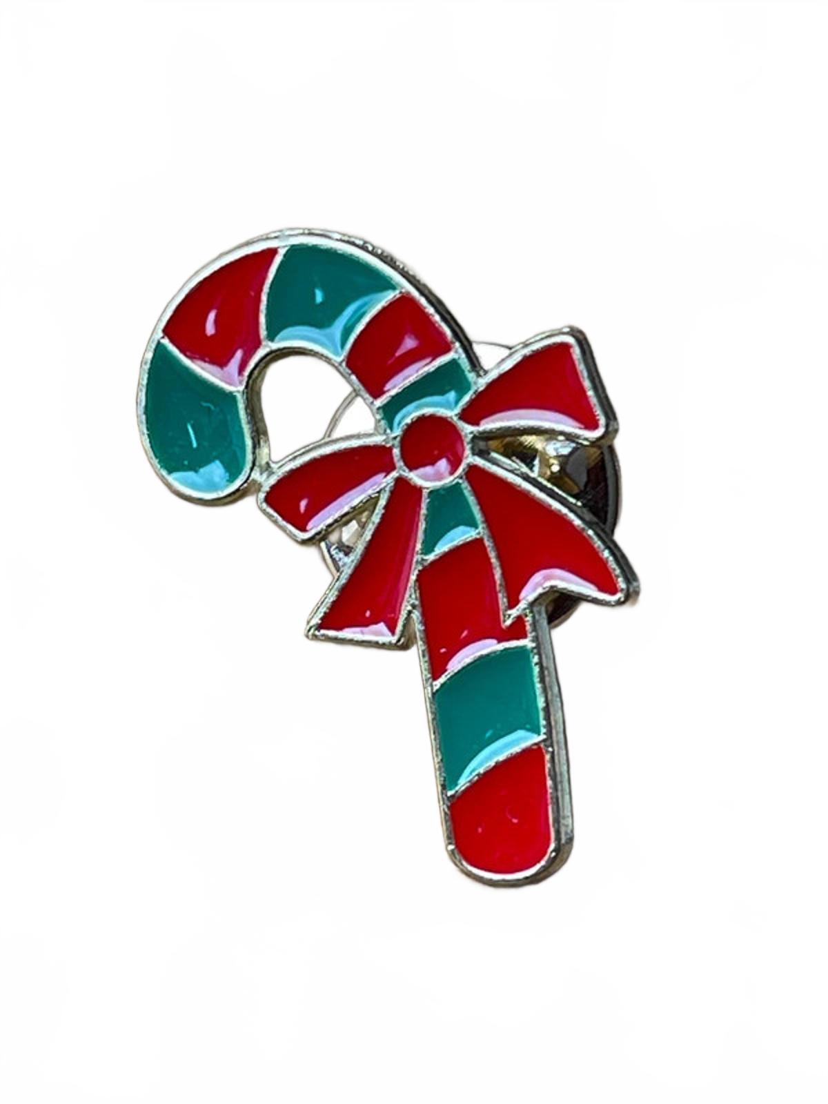 Cute candy cane enamel pin with a red bow on a white background