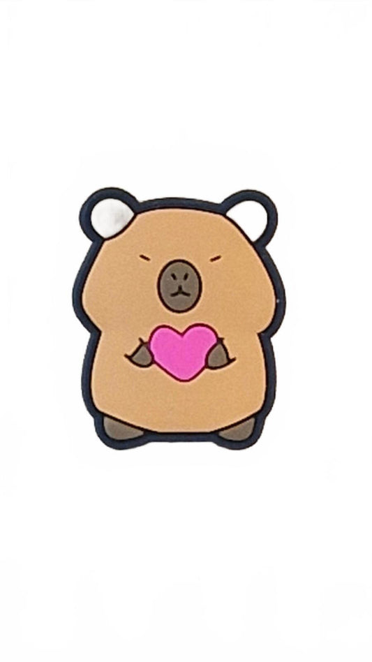 Cute capybara holding pink heart shoe charm