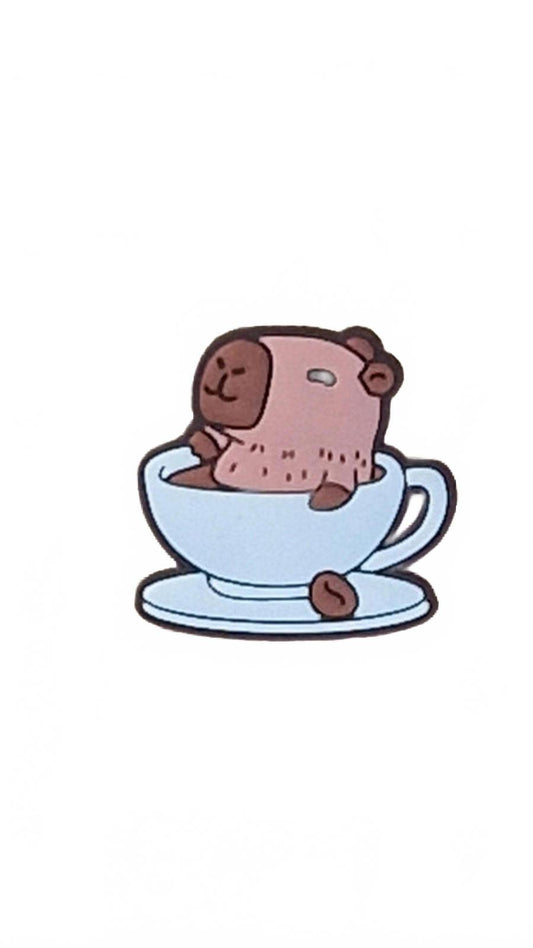 Cute capybara sitting in cup with saucer and coffee bean shoe charm