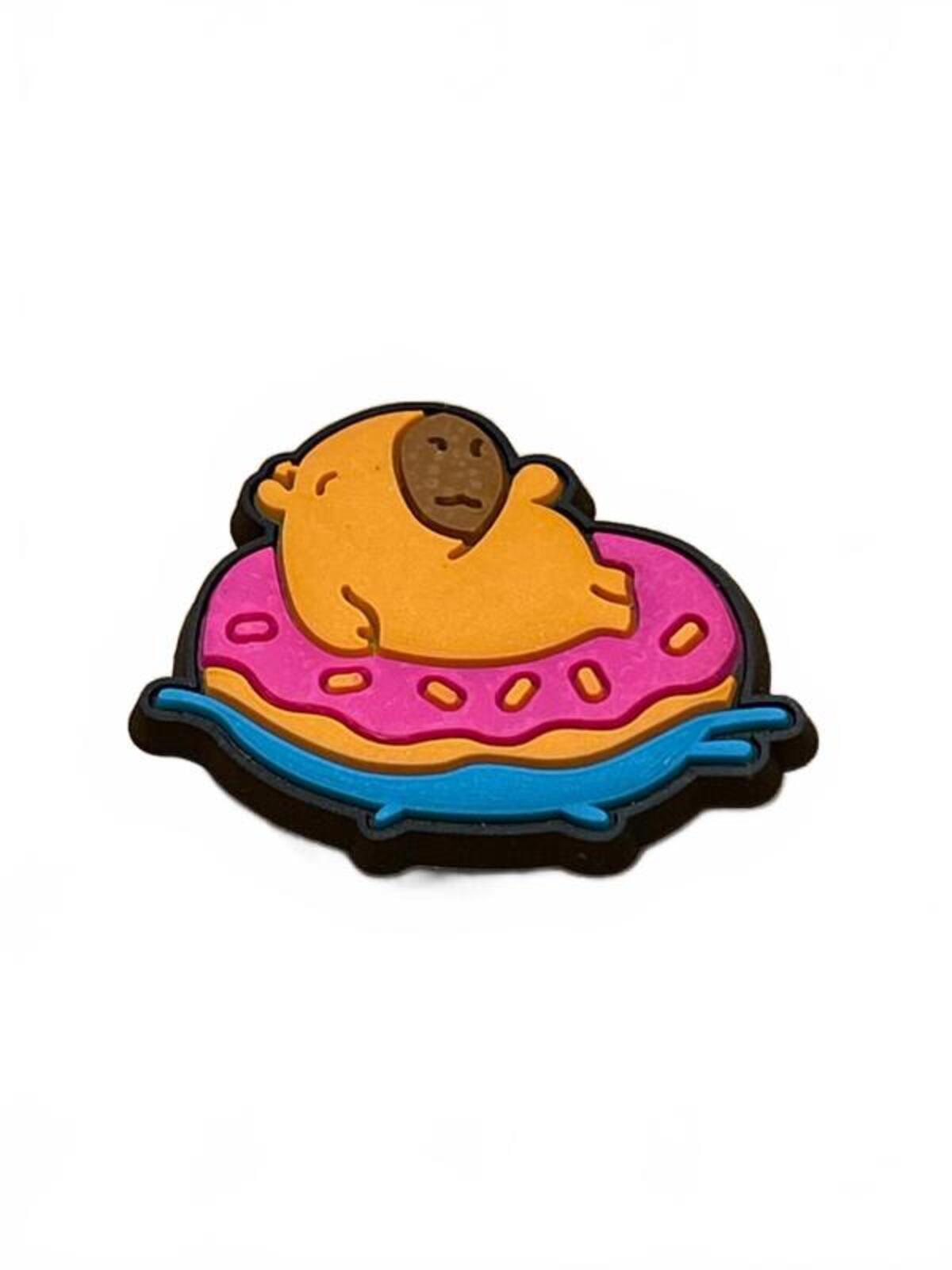Cute capybara floating in pink dotted inflatable doughnut shoe charm