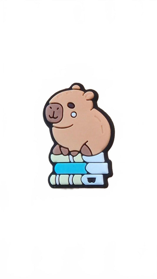 Cute capybara sitting on pile of books shoe charm