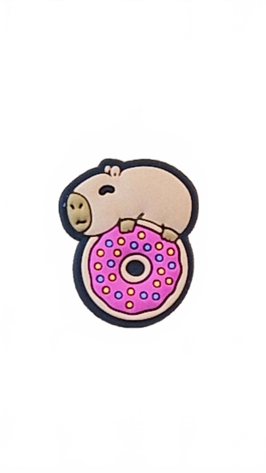 Cute capybara on top of pink dotted doughnut shoe charm