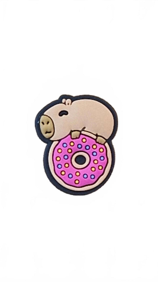 Cute capybara on top of pink dotted doughnut shoe charm