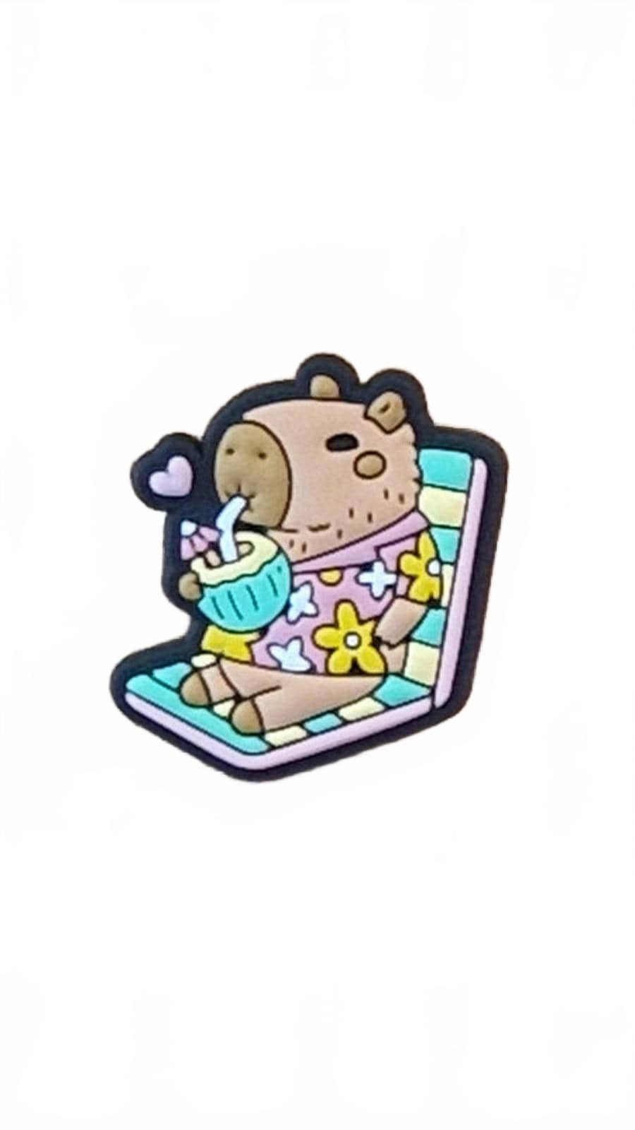 Cute capybara on deckchair with coconut drink and straw shoe charm