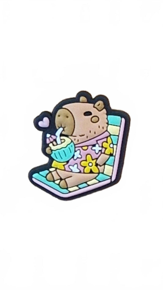 Cute capybara on deckchair with coconut drink and straw shoe charm