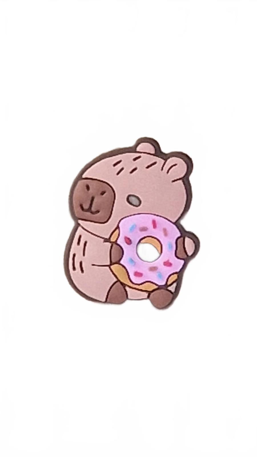 Cute capybara holding pink icing doughnut shoe charm