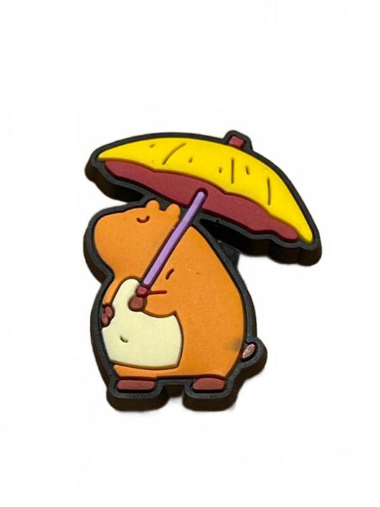 Cute capybara shielding under large yellow umbrella shoe charm
