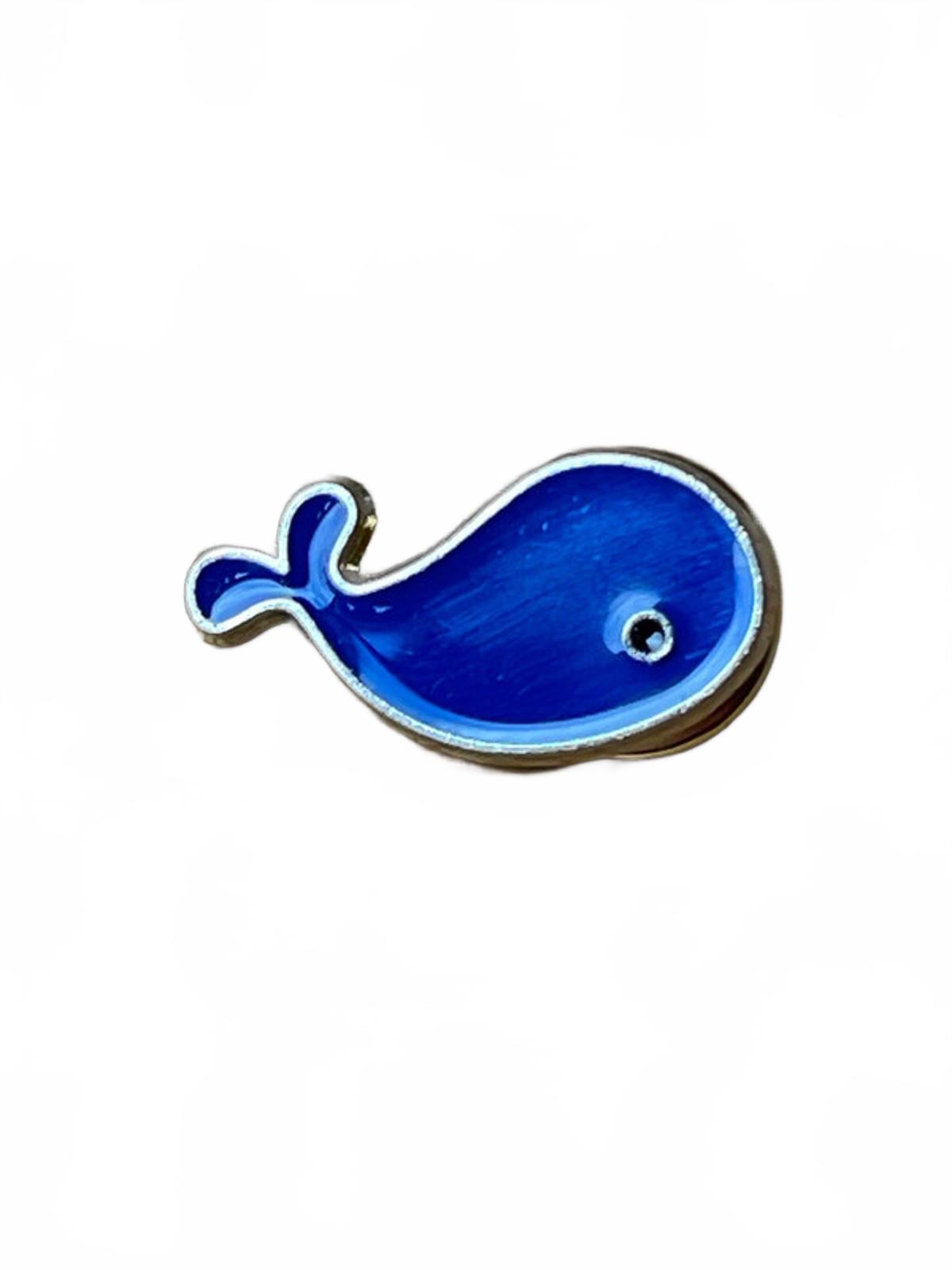 Cute kawaii blue whale enamel pin on a white background