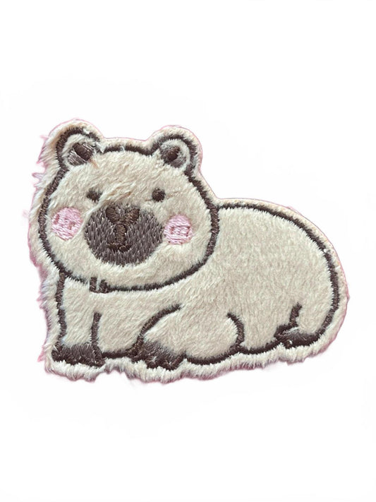 Embroidered patch of a capaybara on a white background
