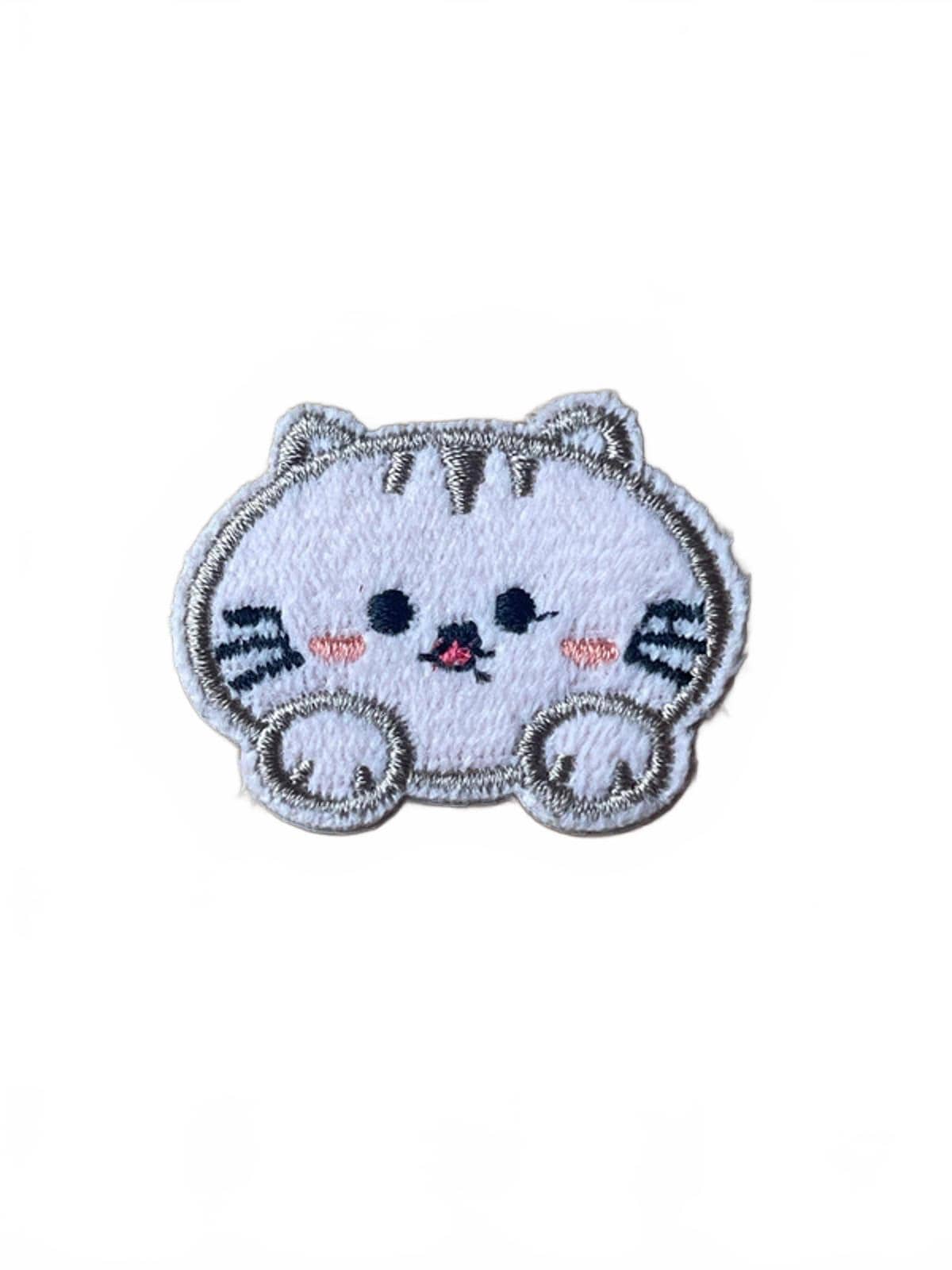 Planet Kawaii cute embroidered patch of a cartoon cat face on a white background