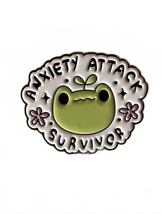 Pin with a cartoon frog design and text 'Anxiety Attack Survivor' on a white background