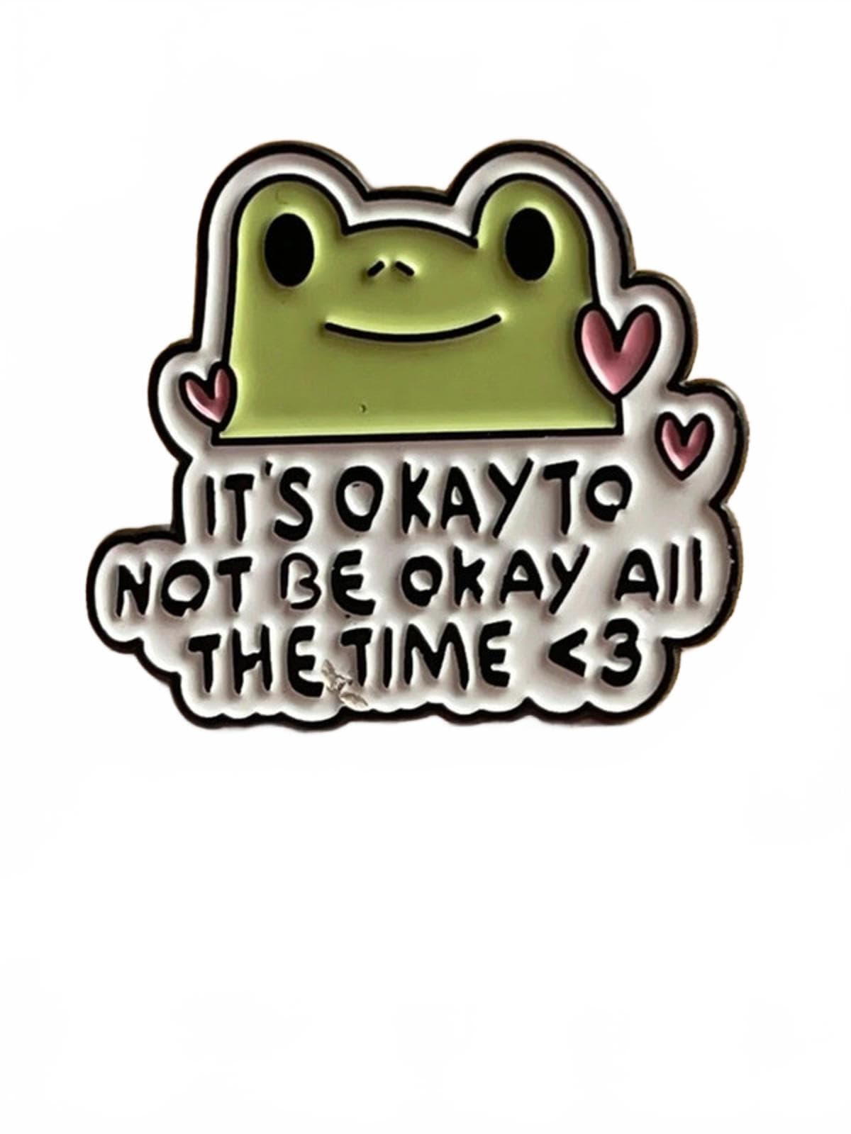 Frog-shaped badge with motivational quote on a white background enamel pin
