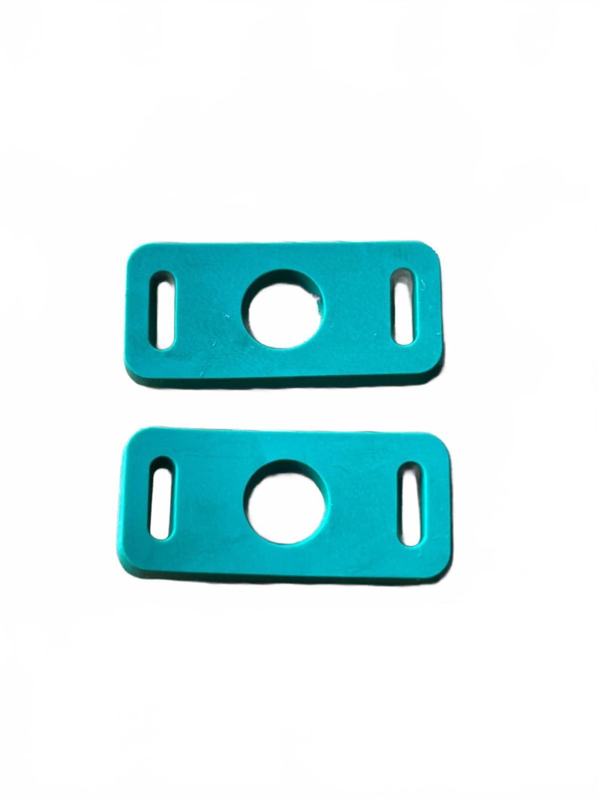 Two green metal shoe charm clip adapters on a white background