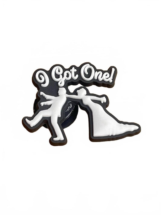 Pin with stick figures in wedding attire and 'Got One!' text on a white background