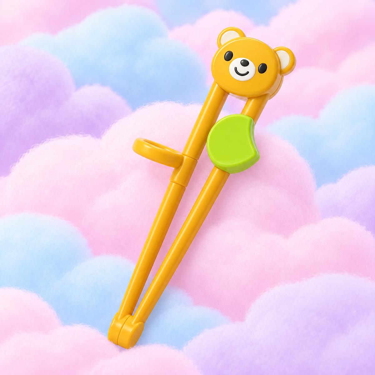 Packaged yellow bear training chopsticks with a guide ring on fluffy pastel clouds.