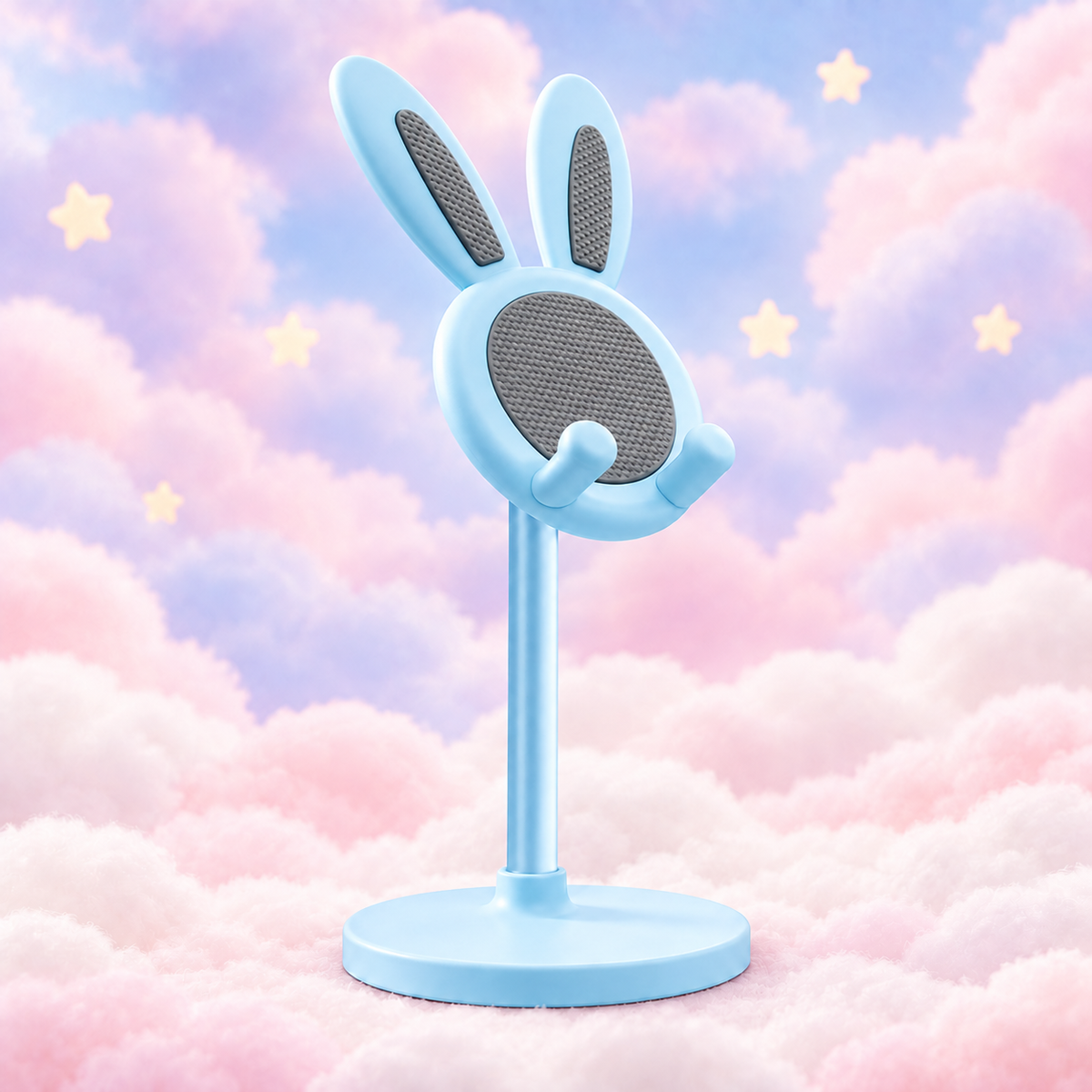 Blue bunny phone stand with grey textured pads and a circular base on pastel clouds.