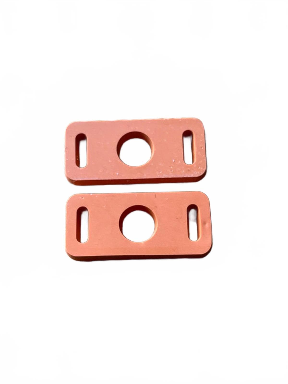 Two orange clip shoe adaptors for laces on a white background