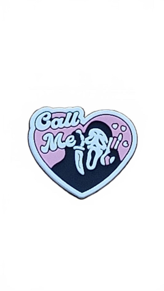Heart-shaped shoe charm with 'Call Me' text and scream mask on a white background