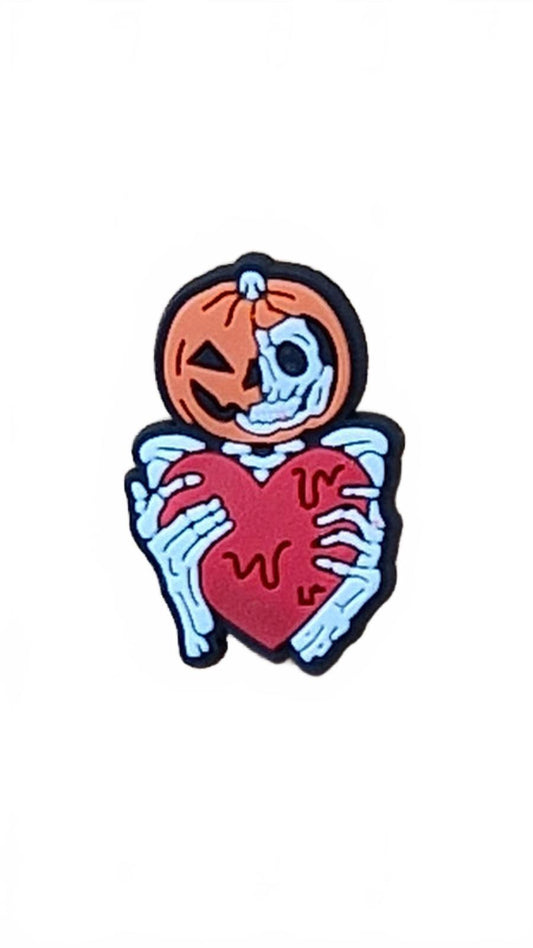 Skeleton holding melting red heart with pumpkin hat shoe charm