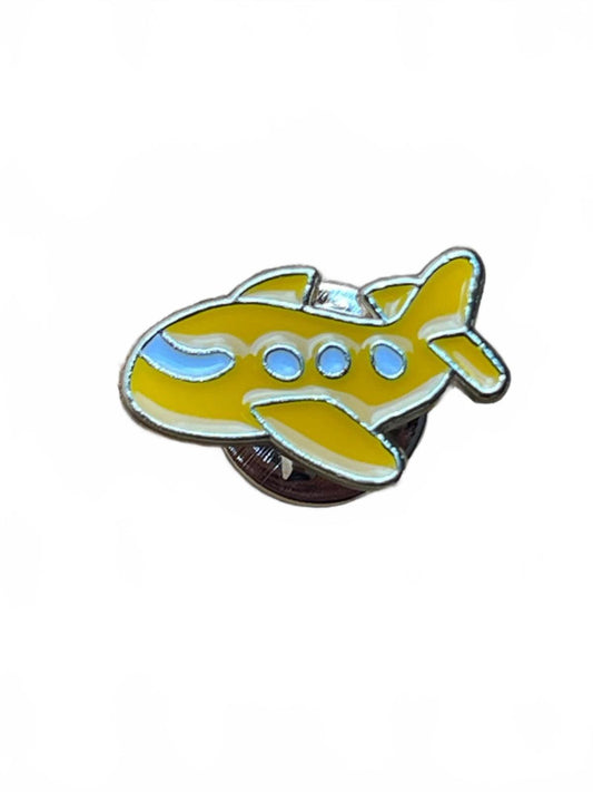 Yellow airplane-shaped pin on a white background